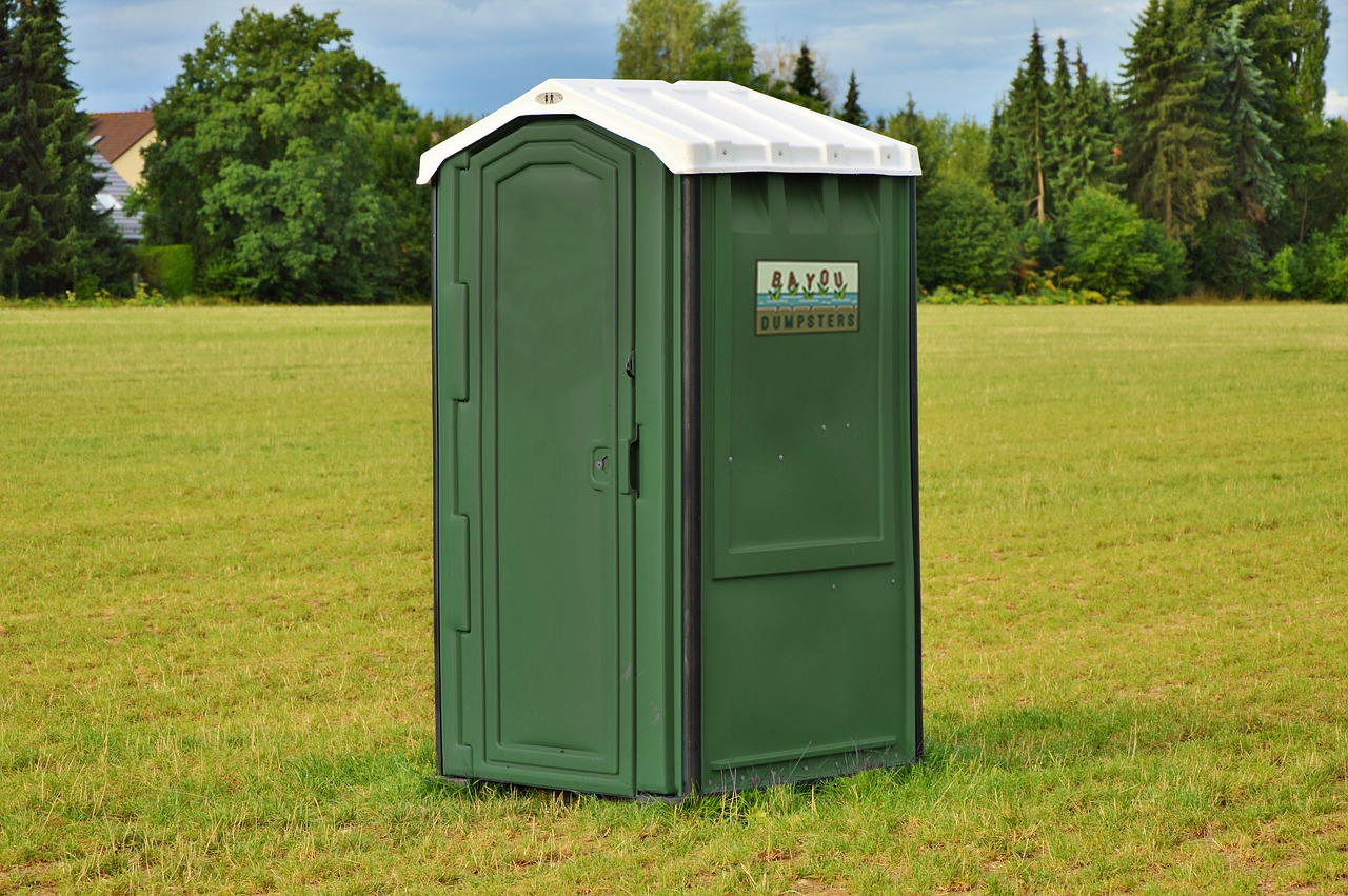 portable toilet in the middle of field