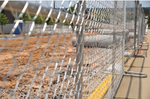 A picture of a temporary fence on a construction site.